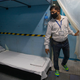An employee of Indian Railways inspects the converting of a train coach into an isolation ward.